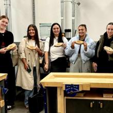 Students show off their wooden boats as part of the program